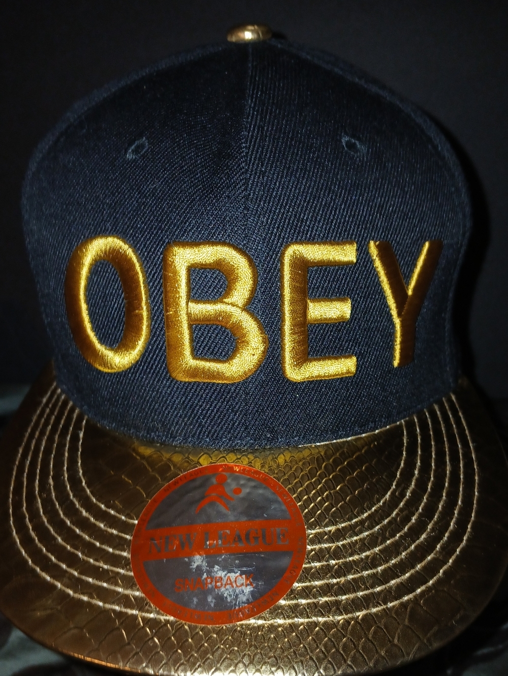Pre-loved Men's OBEY Black and Gold Snapback Hat.